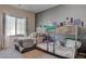 bedroom with a bunkbed and extra bed, perfect for siblings or sleepovers, featuring modern gray decor at 4705 Blaise Ave # 101, North Las Vegas, NV 89084