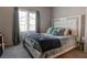 Comfortable bedroom featuring a large bed, ample natural light, and stylish decor at 4705 Blaise Ave # 101, North Las Vegas, NV 89084