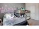 Shared bedroom with a bunk bed and a twin bed, featuring playful wall decor at 4705 Blaise Ave # 101, North Las Vegas, NV 89084