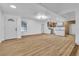 Open-concept living room with wood flooring leading to the kitchen, featuring modern lighting at 528 Sheffield Dr, Henderson, NV 89014