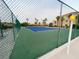 Outdoor tennis court surrounded by lush greenery and a secure fence at 555 Highland Dr # 226, Mesquite, NV 89027