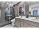 Modern bathroom showcasing double vanity sinks, a toilet, glass shower, and gray tile at 556 Caribbean Palm Dr, Las Vegas, NV 89138