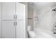 Sleek bathroom design with white cabinets and a tub-shower featuring marble-look tiling at 6 Megan Dr, Henderson, NV 89074