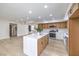 Open kitchen with an island featuring stone countertops and wood cabinets at 6 Megan Dr, Henderson, NV 89074