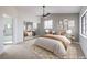 Well-lit main bedroom featuring carpet floors, ceiling fan, and modern decor at 6 Megan Dr, Henderson, NV 89074
