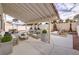 Covered outdoor patio with comfortable seating and desert landscaping at 6 Megan Dr, Henderson, NV 89074