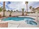Resort style pool and hot tub featuring mature trees and a rock border, ideal for relaxation at 6 Megan Dr, Henderson, NV 89074