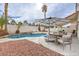 Outdoor area featuring a pool with lounge chairs, covered seating area, and desert landscaping at 6 Megan Dr, Henderson, NV 89074
