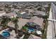 Expansive aerial view of a home featuring a pool, spa, and spacious backyard with palm trees in a residential neighborhood at 6392 Ebony Legends Ave, Las Vegas, NV 89131
