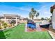 Lush backyard with a pergola, grill, and lounge chair near a pristine pool at 6392 Ebony Legends Ave, Las Vegas, NV 89131