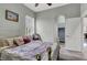 Comfortable bedroom with neutral colors and wood floors with an ensuite bathroom at 6392 Ebony Legends Ave, Las Vegas, NV 89131