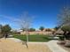 A well-maintained community park with green space, benches, and mature landscaping for residents to enjoy at 6392 Ebony Legends Ave, Las Vegas, NV 89131