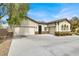 Lovely home showcasing a three-car garage and stone accents at 6392 Ebony Legends Ave, Las Vegas, NV 89131