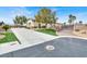 A welcoming entrance through gates into this private property, showcasing curb appeal with lush landscaping at 6392 Ebony Legends Ave, Las Vegas, NV 89131