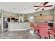 Well-lit kitchen features a breakfast bar, stainless appliances, and open layout with adjacent dining area, perfect for modern living at 6392 Ebony Legends Ave, Las Vegas, NV 89131