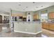 Modern kitchen with stainless steel appliances, a breakfast bar, and ample cabinet space, ideal for cooking and entertaining at 6392 Ebony Legends Ave, Las Vegas, NV 89131