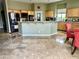 A wide-angle view of the kitchen featuring maple cabinets, light green walls, and a tile floor at 6392 Ebony Legends Ave, Las Vegas, NV 89131