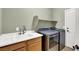 Laundry room features modern washer and dryer units, a sink, and a shelf at 6392 Ebony Legends Ave, Las Vegas, NV 89131
