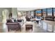 Bright and airy living room with marble floors, stylish seating, and an open design flowing into the kitchen at 6392 Ebony Legends Ave, Las Vegas, NV 89131
