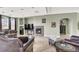 Cozy living room with a fireplace, marble floors, and comfortable seating, perfect for relaxing and entertaining guests at 6392 Ebony Legends Ave, Las Vegas, NV 89131