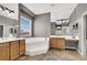 Elegant bathroom with a soaking tub, double vanities, and a large mirror at 6392 Ebony Legends Ave, Las Vegas, NV 89131