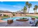 Beautiful backyard swimming pool featuring a unique waterfall and inviting lounging areas at 6392 Ebony Legends Ave, Las Vegas, NV 89131