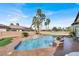 Stunning backyard pool with a tiered waterfall feature and surrounding landscaping at 6392 Ebony Legends Ave, Las Vegas, NV 89131