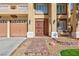 Inviting front entrance with secure door, brick steps, manicured lawn, and beautiful desert landscaping at 6578 Chimes Tower Ave, Las Vegas, NV 89139