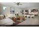 Open-concept living space featuring a plush white sofa, modern decor, and seamless flow into a stylish kitchen and dining area at 6818 Sweet Bay St # Lot 11, Las Vegas, NV 89166