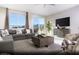 Comfortable living room features a large sectional sofa, plush rug and mountain views at 6826 Sweet Bay St # Lot 10, Las Vegas, NV 89166
