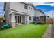 Lush backyard featuring artificial turf, a trampoline, covered patio, and neutral colors at 683 Quasi St, Henderson, NV 89011