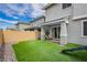 Beautiful backyard featuring artificial turf, a trampoline, covered patio, and block wall at 683 Quasi St, Henderson, NV 89011