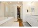 Modern bathroom with double vanity, soaking tub, glass shower, and walk-in closet at 683 Quasi St, Henderson, NV 89011