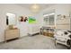 Bedroom with a neutral color palette, featuring a crib, dresser, and shelves with toys and books at 683 Quasi St, Henderson, NV 89011