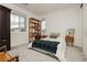 Cozy bedroom featuring a queen bed, dark wood armoire, and a bright window at 683 Quasi St, Henderson, NV 89011