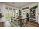 Dining room featuring glass doors to the backyard, wood floors, and natural light at 683 Quasi St, Henderson, NV 89011