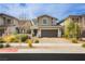 Charming two-story home with a well-manicured front yard and a brick paved driveway at 683 Quasi St, Henderson, NV 89011