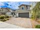 Attractive home with a paved driveway, two car garage, manicured landscaping, and inviting entrance at 683 Quasi St, Henderson, NV 89011