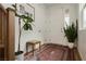 Foyer features a patterned rug, a bench seat, and decoratively placed green plants at 683 Quasi St, Henderson, NV 89011