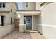 Inviting front entrance with a gray door, wreath, neutral colors, and stone paved walkway at 683 Quasi St, Henderson, NV 89011