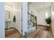 Hallway featuring wood-look floors, a half-bath, and staircase leading to the upper level at 683 Quasi St, Henderson, NV 89011