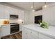 Modern kitchen featuring white cabinetry, stainless steel appliances, and elegant countertops at 683 Quasi St, Henderson, NV 89011