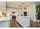 Modern kitchen with white cabinets, stainless steel appliances, and a large center island at 683 Quasi St, Henderson, NV 89011