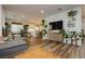 Spacious living room, with lots of plants, that flows to the dining and kitchen areas at 683 Quasi St, Henderson, NV 89011