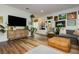 Comfortable living room, with lots of plants, that flows to the dining and kitchen areas at 683 Quasi St, Henderson, NV 89011