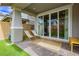 Relaxing covered patio with sliding glass doors, neutral stone pavers, and comfortable seating at 683 Quasi St, Henderson, NV 89011