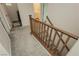 Carpeted staircase with wood railing leading upstairs, with views to the laundry room and bathroom at 683 Quasi St, Henderson, NV 89011