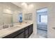 Bright bathroom with a double sink vanity and a view into the bedroom and shower at 7232 N Decatur Blvd # 4, Las Vegas, NV 89131