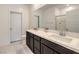 Modern bathroom featuring a double sink vanity with sleek, dark cabinetry and a large mirror at 7232 N Decatur Blvd # 4, Las Vegas, NV 89131