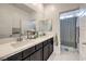 Bathroom featuring double sinks, dark cabinets, and a shower with patterned curtain at 7232 N Decatur Blvd # 4, Las Vegas, NV 89131